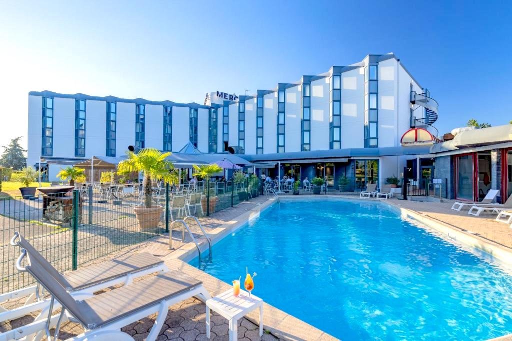 The secure swimming pool, terrace, and Mercure Hotel in Villefontaine on the A43 east of Lyon.