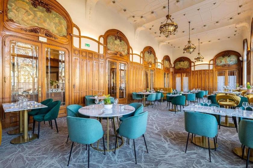 The dining room, with Art Nouveau-style wood panelling, at the Mercure Lyon Centre Perrache hotel