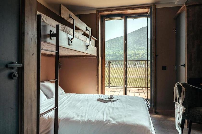 One of the triple rooms in the self-catering accommodation at La Tour de Contrôle, offering a direct view of the airfield runway.